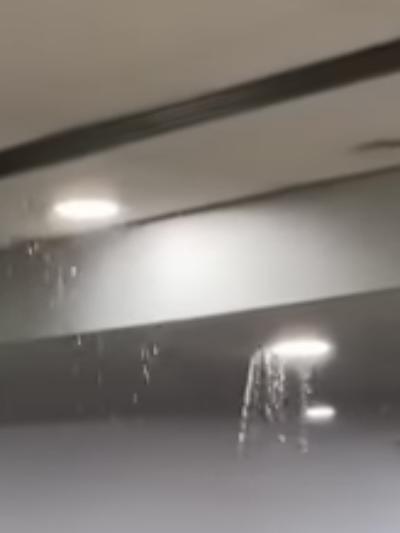 Water pours through the roof of a departure lounge at Melbourne Airport on Thursday. Picture: Jacqui Felgate