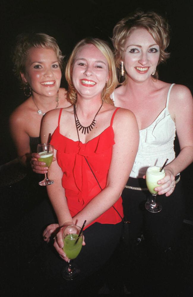 Kelli Martell, Emily Moore and Simone Green share some drinks at the Rolling Rock nightclub in May 2002. Picture: Sharyn Rosewarne