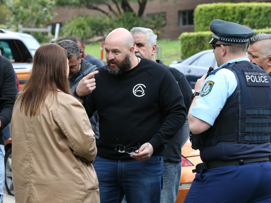 Protestors have begun to gather outside Kiis FM headquarters in North Ryde to protest against comments Kyle Sandilands made about Christians and the Virgin Mary. An ARN staffer (lady pictured in brown jacket) came and spoke to the protestors. Picture: David Swift.