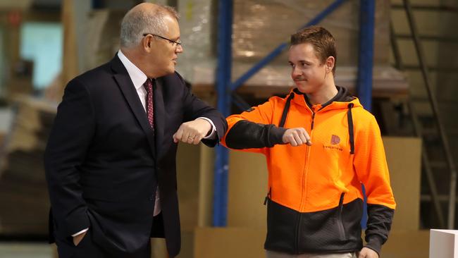 Scott Morrison with a DisplayWise employee at a workshop in Miranda, southern Sydney, on Monday. Picture: Getty Images