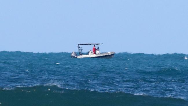 Police search in waters just off Granite Beach. Picture: Simon Cross