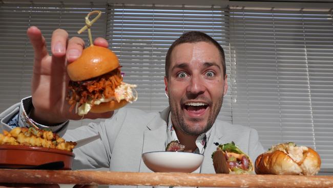 Hit90.9 presenter Dan Anstey with some of the food he’ll be indulging in on September 1. Picture: Glenn Hampson.