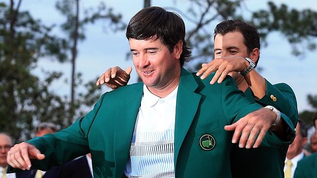 Adam Scott presents Bubba Watson with the green jacket after the American won his second Masters title.