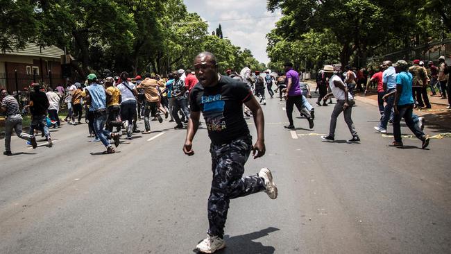 Protesters scatter as police open fire with rubber bullets outside Congo's embassy in Pretoria, South Africa. Picture: AFP/John Wessels