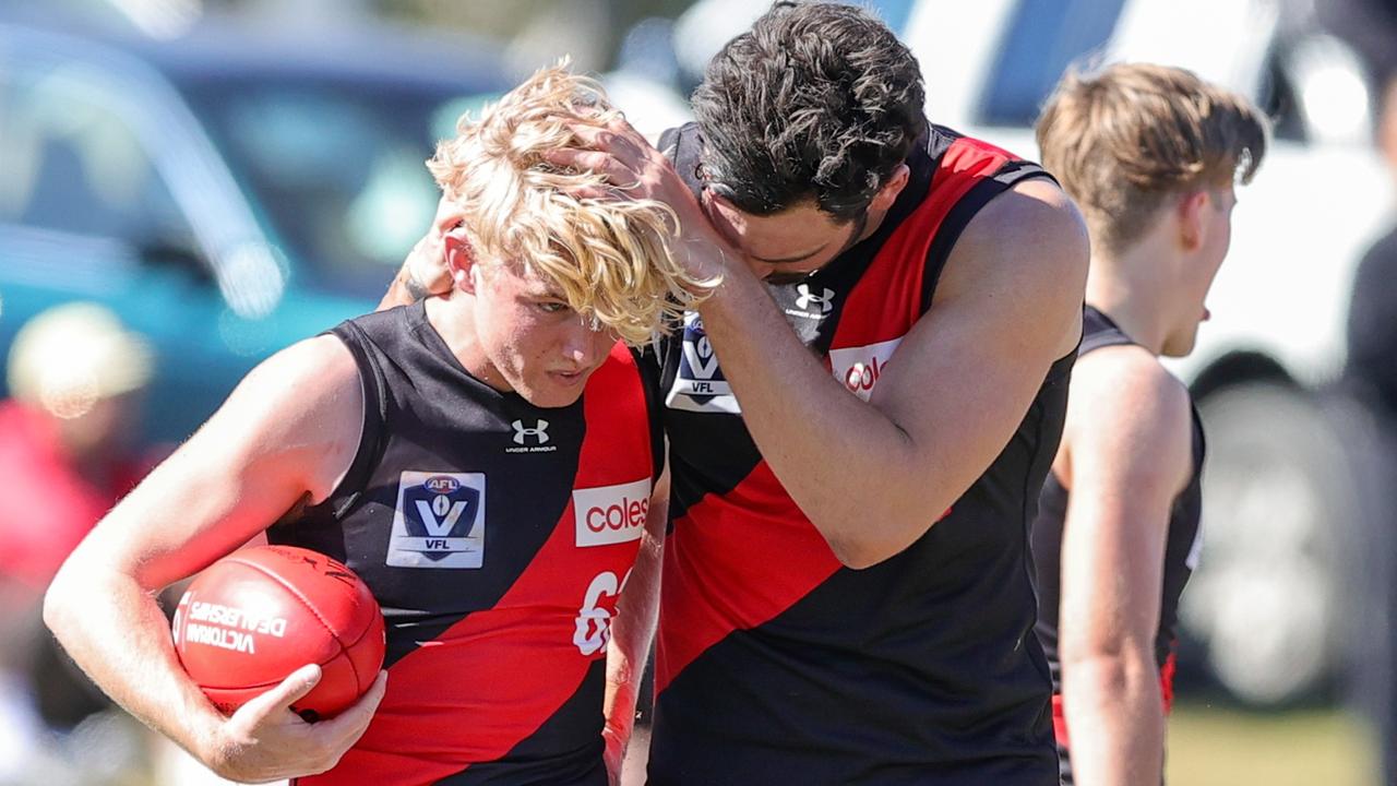 Bombers youngster Tom Hird is spoken to by Patrick McCartin during a VFL practice match against Southport Sharks.