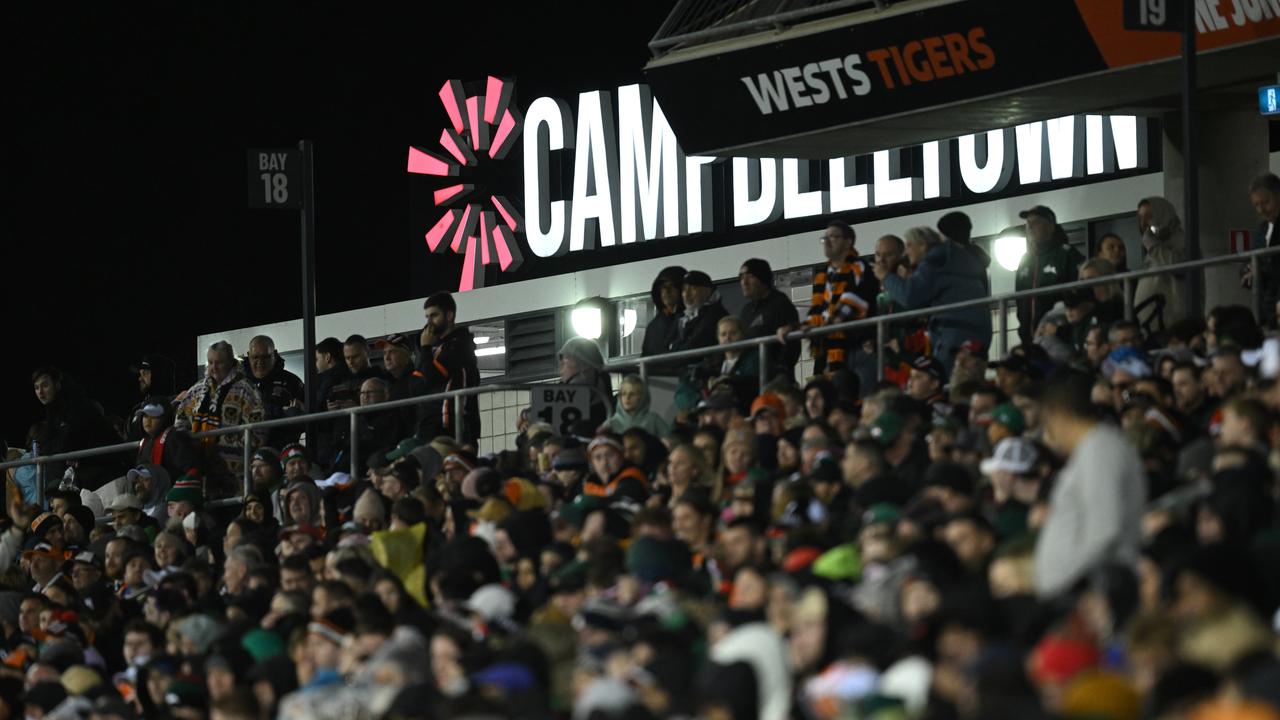 Two hospitalised, police injured after wild fan brawl at NRL game