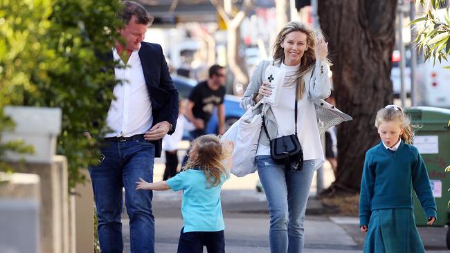 Anthony Bell and Kelly Landry take a stroll with their kids last September.