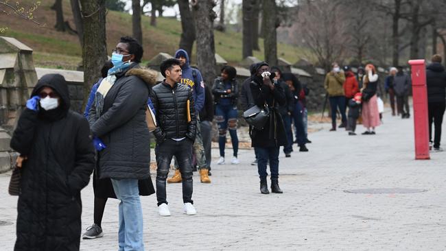 People who believe they have COVID-19 and who meet the criteria wait in line to be pre-screened for the corona virus outside of the Brooklyn Hospital Center. Picture: AFP