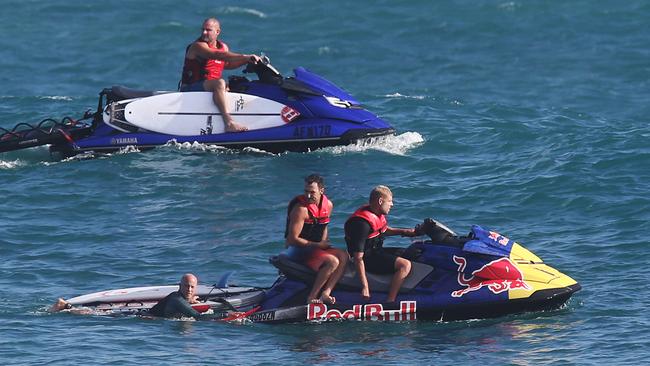 Cyclone Oma is agony for some and ecstasy for others. Surfers enjoy great waves at Kirra. Joel Parkinson and Mick Fanning give friends a tow back to the line up. Picture Glenn Hampson