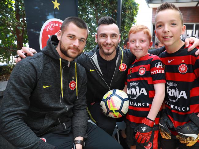 L-R Western Sydney Wanderers players Brendan Hamill and Vedran Janjetovic sign a ball for 9 year old Callum Garbers and his brother 11 year old Harrison Garber in Stanhope Gardens. Stanhope Gardens, Friday, July 13th 2018. The Western Sydney Wanderers will be holding a meet and greet with fans at The Coffee Emporium, Stanhope Village Shopping Centre. (AAP Image / Angelo Velardo)