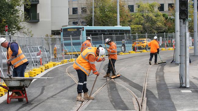 Workers putting the finishing touches on upgrades along St Kilda Road. Picture: Ian Currie