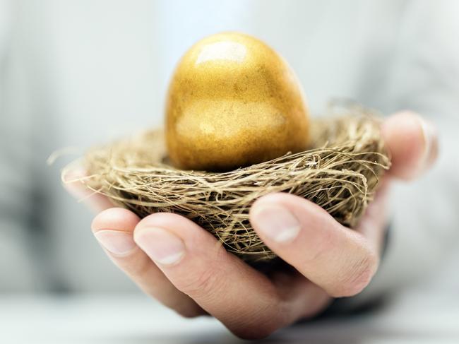 Retirement savings golden nest egg in a businessman's hand, superannuation generic