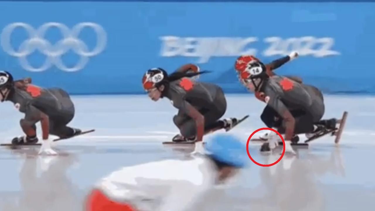 Chinese speed skater Kexin Fan appears to flick a marker towards a Canadian rival during the Winter Olympics.