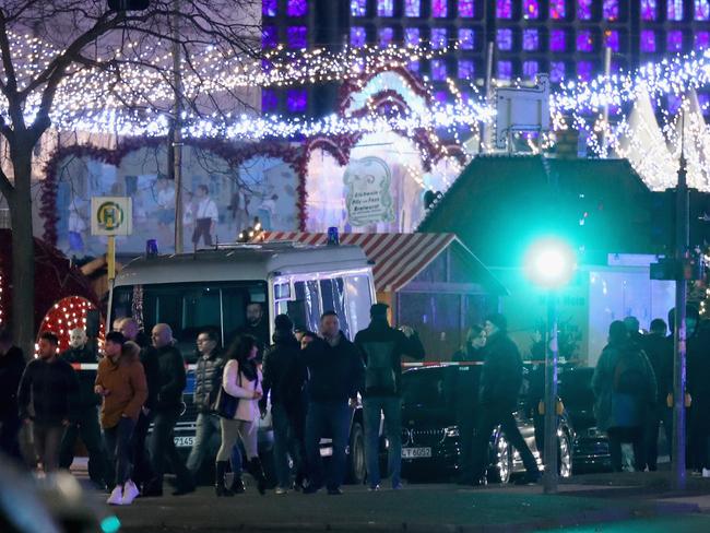 People stand at the area after a lorry truck ploughed through a Christmas market on December 19, 2016 in Berlin, Germany. Picture: Getty