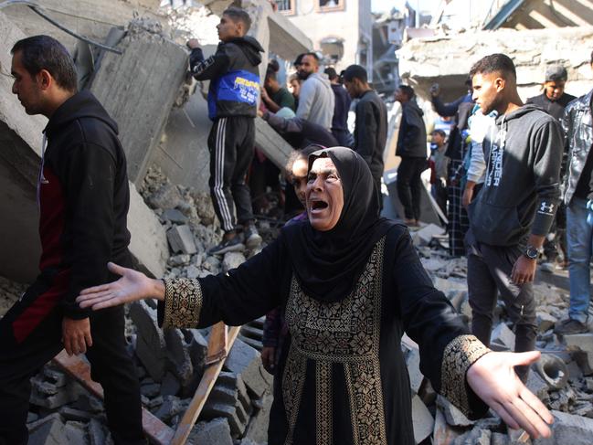 A Palestinian woman reacts as she stands amid the rubble of a building destroyed in an Israeli strike on the Shujaiyah neighbourhood in Gaza City on Saturday. Picture: AFP