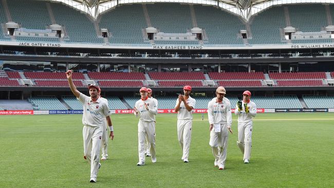 Chadd Sayers of the Redbacks walks from the field with team mates after taking eight wickets during the Sheffield Shield match between South Australia and New South Wales at Adelaide Oval. Picture: AAP Image/David Mariuz