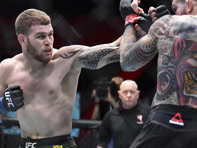 LAS VEGAS, NEVADA - MARCH 06: (L-R) Jake Matthews of Australia punches Sean Brady in their welterweight fight during the UFC 259 event at UFC APEX on March 06, 2021 in Las Vegas, Nevada. (Photo by Chris Unger/Zuffa LLC)