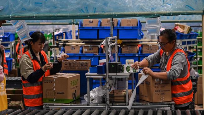 Employees in the warehouse of Cainiao Smart Logistics Network, the logistics affiliate of e-commerce giant Alibaba, in Wuxi, China's eastern Jiangsu province. Picture: AFP