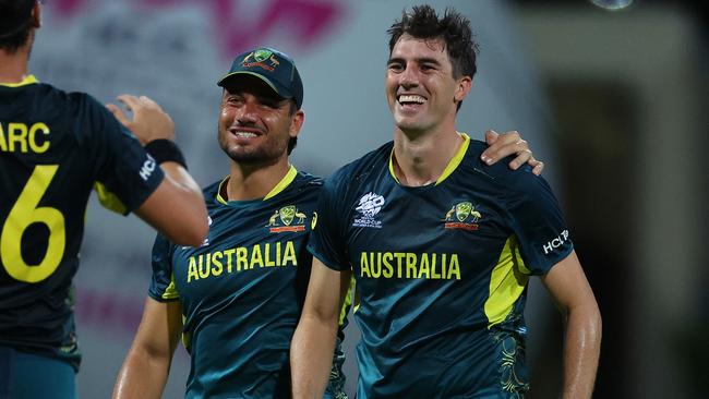 ANTIGUA, ANTIGUA AND BARBUDA - JUNE 20: Pat Cummins of Australia celebrates with teammates Marcus Stoinis and Mitchell Starc after dismissing Taskin Ahmed of Bangladesh (not pictured) for his hat trick during the ICC Men's T20 Cricket World Cup West Indies & USA 2024 Super Eight match between Australia and Bangladesh at Sir Vivian Richards Stadium on June 20, 2024 in Antigua, Antigua and Barbuda. (Photo by Jan Kruger-ICC/ICC via Getty Images)