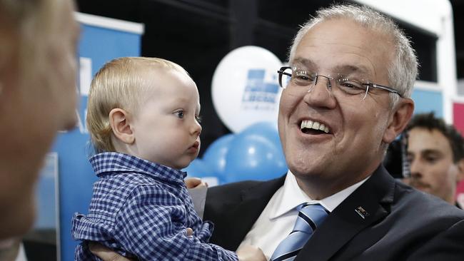 Scott Morrison holds a baby during a Liberal Party campaign rally at Launceston Airport on April 18. Picture: RYAN PIERSE/GETTY IMAGES