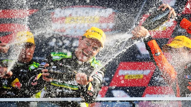 Podium carnage as Craig Lowndes celebrates.