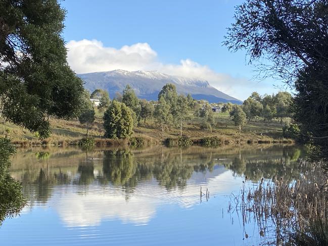 Sun shines over a snow-capped kunanyi/Mt Wellington. Picture: Philip Young