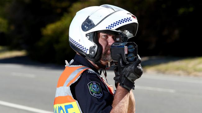 A policeman using a speed laser gun. Picture: Simon Cross