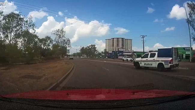 Dashcam footage has shown a police vehicle narrowly avoiding colliding with a Darwin motorist on the Stuart Hwy. Video: Brett Perry