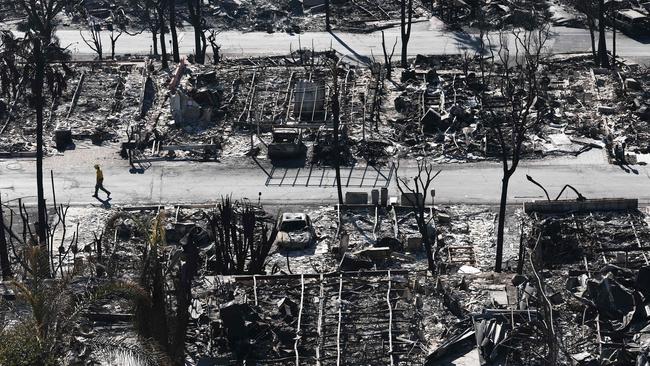 A firefighter walks past homes destroyed in the Palisades Fire. Picture: Getty Images