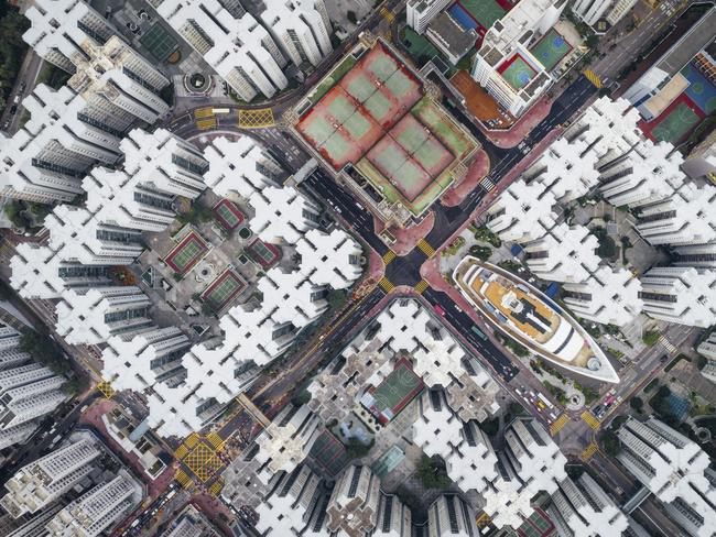 Walled City #08 The Kowloon Walled City was the densest place on Earth. Hundreds of houses stacked on top of each other enclosed in the center of the structure. Many didn’t have access to open space.This notorious city was finally demolished in 1990s. However, if you look hard enough, you will notice that the city is not dead. Part of it still exists in many of current high density housing apartments. I hope this series can get people to think about claustrophobic living in Hong Kong from a new perspective. Picture: Andy Yeung / National Geographic Travel Photographer of the Year