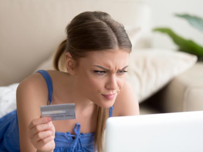 Confused young woman having problem with blocked credit card making rejected unsecure online payment using laptop at home, invalid expired account, transaction failed, money withdraw impossible, debt; ; banking errors and mistakes generic