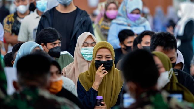 People queue to register for the Sinovac Covid-19 coronavirus vaccine at a convention hall building in Banda Aceh. Picture: AFP