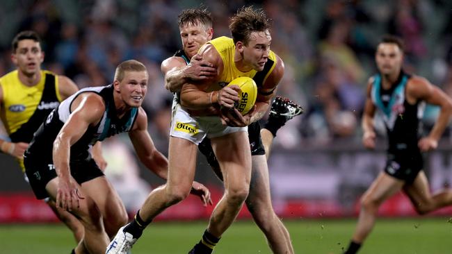 Tom Jonas lays a goal-saving tackle on Tom Lynch. Picture: Getty Images