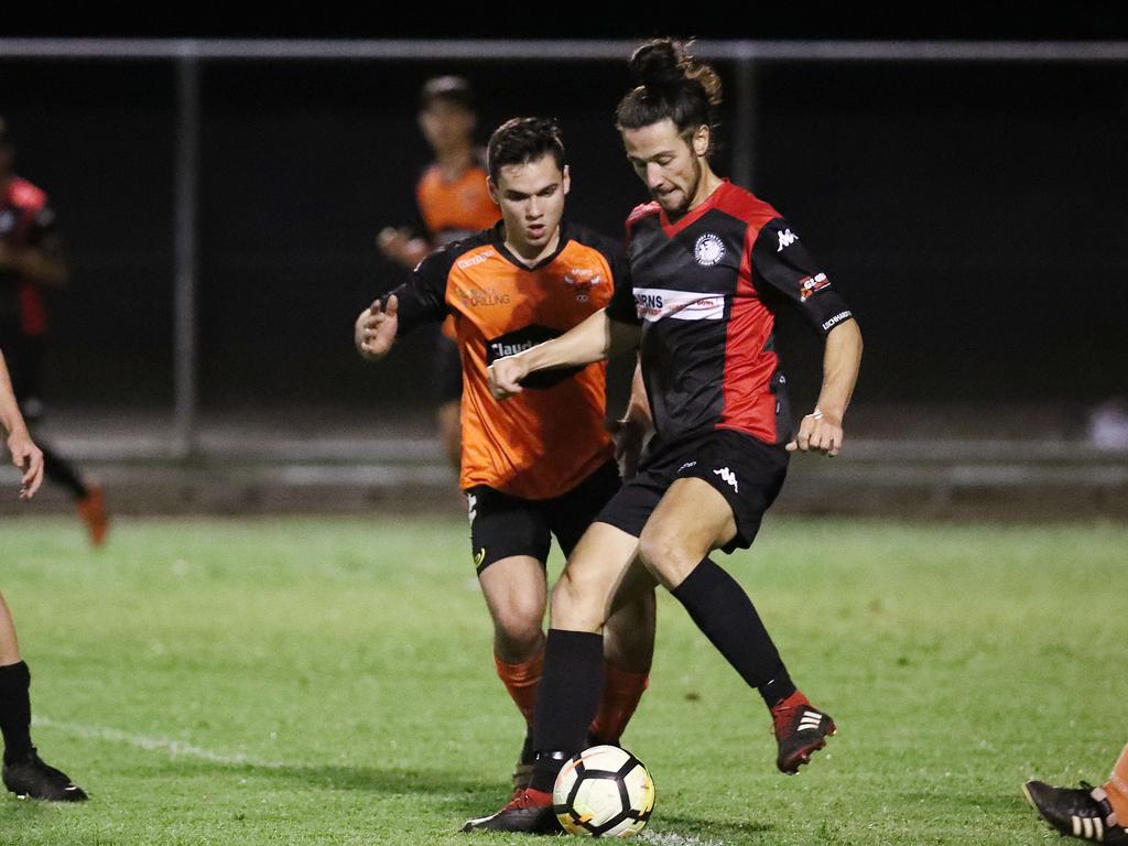 Bulls' Dylan Cummings and Lions' Dan Ting. PICTURE: BRENDAN RADKE