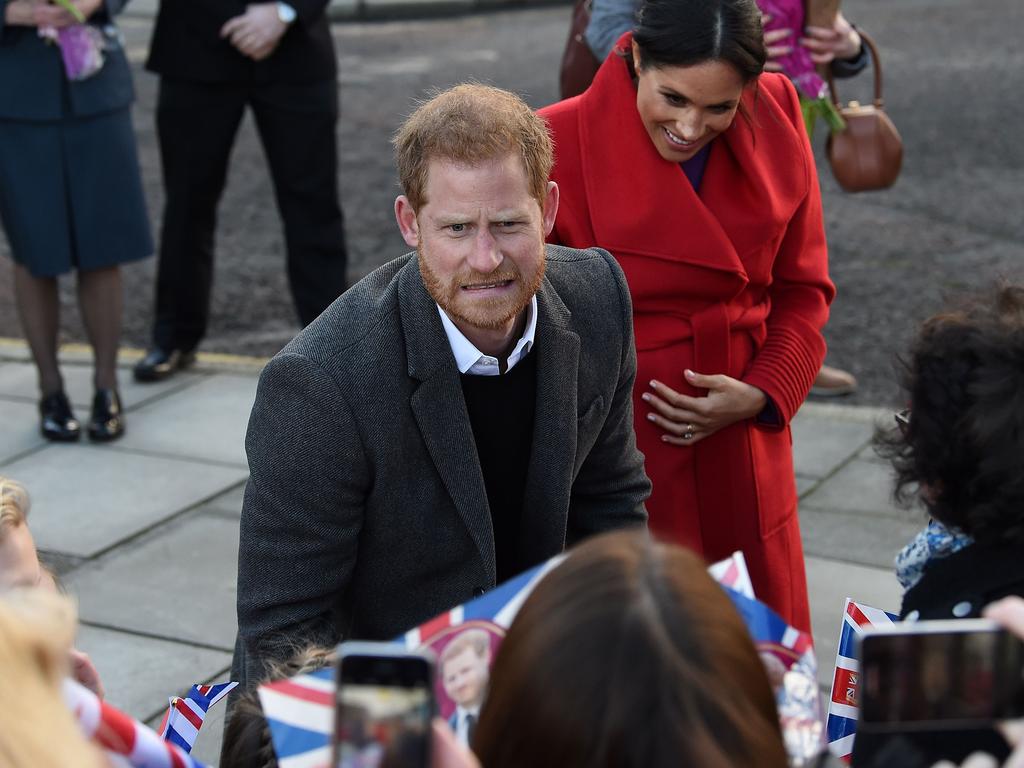 Prince Harry reacts as he and his wife Meghan, Duchess of Sussex greet wellwishers.