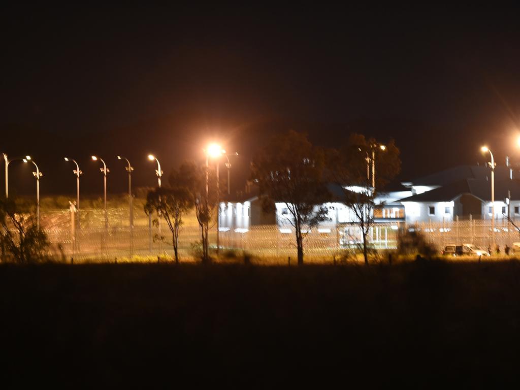 Police vehicles at the perimeter of the Capricornia Correctional Centre late on Thursday night during the riots and protests.