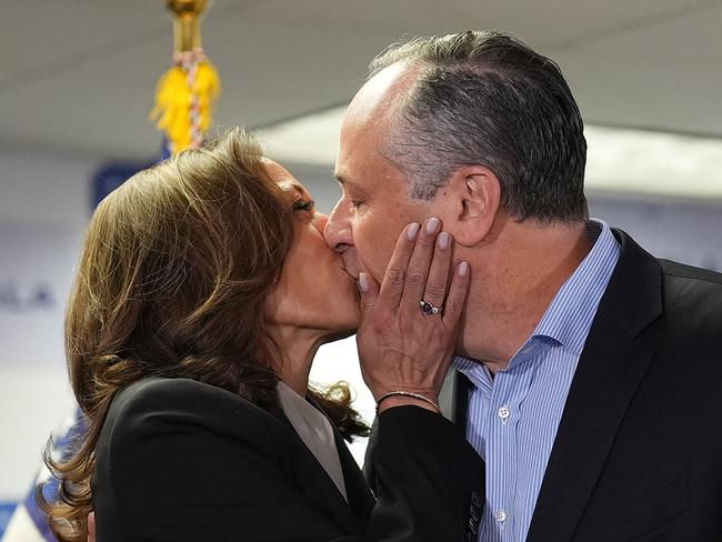 US Vice President and Democratic presidential candidate Kamala Harris and Second Gentleman Doug Emhoff share a smooch. Picture: Erin Schaff/POOL/AFP