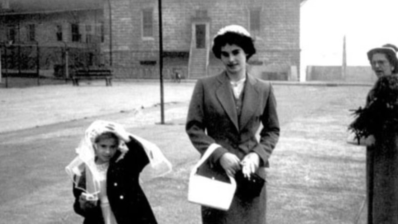 Babyak and her eleven-years-older sister, Corinne, on the island. Mum Evelyn keeps watch on the far right. They all stand on the children's main playground. Picture: The Dollison Family via Realtor