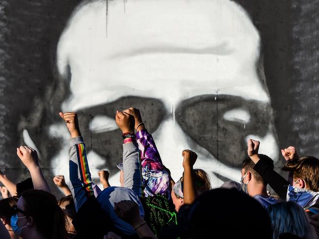 People raise their hands as they protest at the makeshift memorial in honour of George Floyd, a 46-year-old black man who died in Minneapolis after Derek Chauvin, a white police officer, pressed his knee to Floyd's neck for almost nine minutes. Picture: AFP