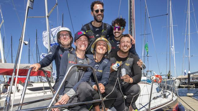 Jessica Watson (centre) with crew members Sam Duncan, Annie Eastgate, Jack Kliner, Steve Quiros and Xavier Doerr after arriving at Hobart on-board the Azzurro. Picture: Chris Kidd