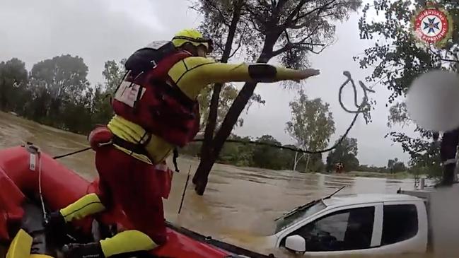 Swift water rescue crews rescued a driver stranded on his ute's roof after his vehicle was swept of the roadway at Balyendo crossing. Image: QFD