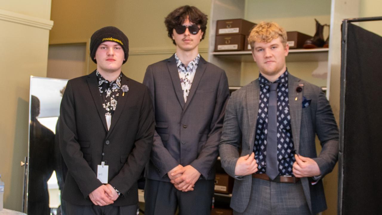 Left: Luke Walker, Tahlo Nicholson-Moss, and Connor McDougall being fitted for their year 12 formal suits at the Lismore Showgrounds.