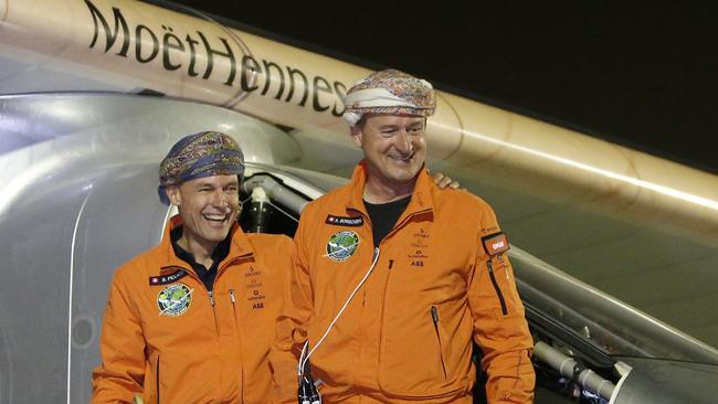 Swiss pilots Bertrand Piccard and Andre Borschberg, both wearing traditional Omani turbans, smile during a welcome ceremony after Solar Impulse 2 landed in the Omani capital Muscat. Picture: AFP.