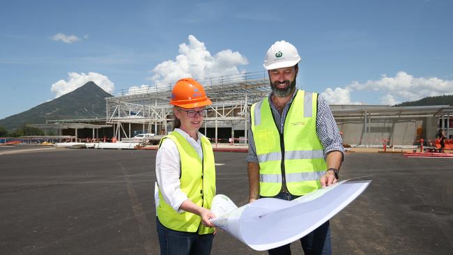 Woolworths regional development manager Marissa Hopewell and state development manager Chris Sheehen look over plans for the new supermarket in front of the construction. Picture: Brendan Radke