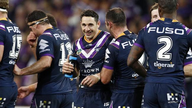 Billy Slater shares a laugh with Cameron Smith after scoring a try against the Sharks.