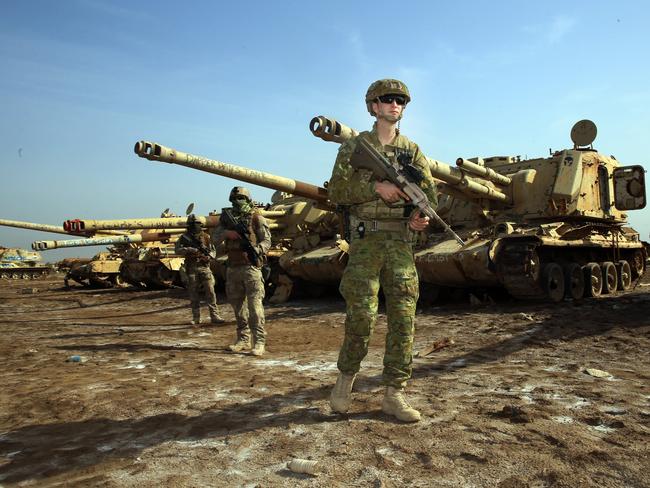 Private Jack Cox, 22 years old from Perth WA, with Kiwi soldiers from the training task group. Picture Gary Ramage