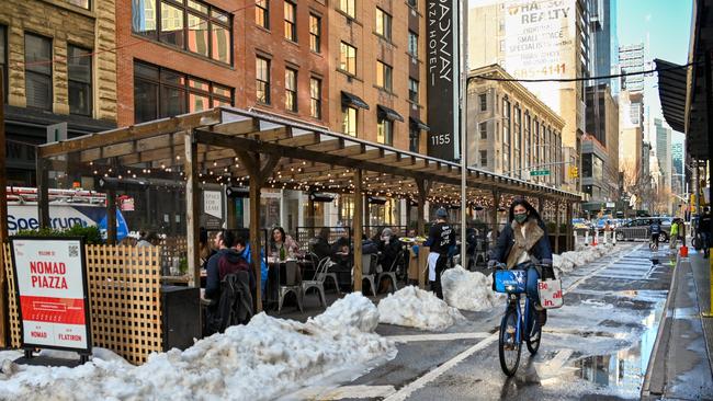 People dine in an outdoor seating area at NoMad Piazza in the NoMad neighborhood of Manhattan. Picture: Getty Images