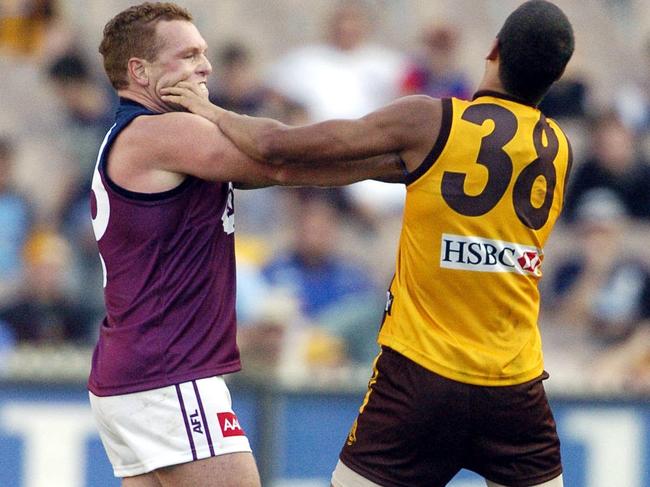 Justin Leppitsch and Lance Franklin engage in a melee during the clash.