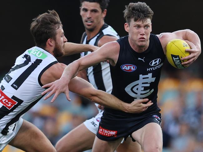 AFL Round 14. Carlton vs Collingwood at the Gabba, Brisbane.. 30/08/2020...  Sam Walsh of the Blues tries to fend of the tackle of Tom Phillips of the Magpies q3  . Pic: Michael Klein