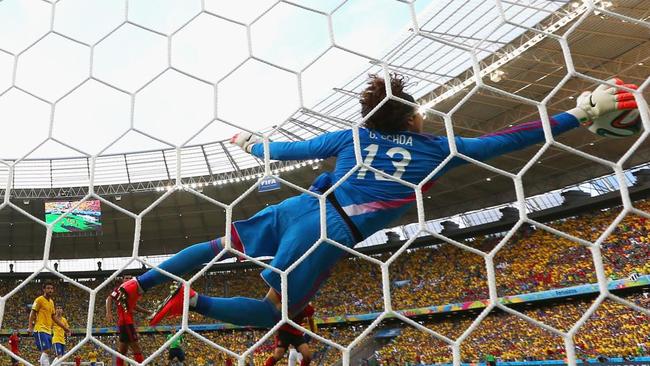 Mexico goalkeeper Guillermo Ochoa dives to make a save against Brazil.